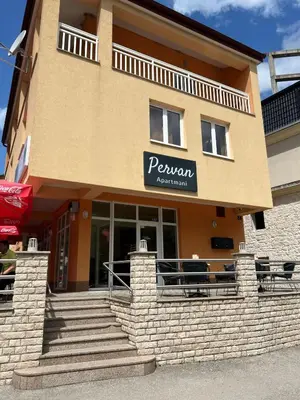 a building with a sign that reads pewan restaurant at Apartmani Pervan 2 in Livno