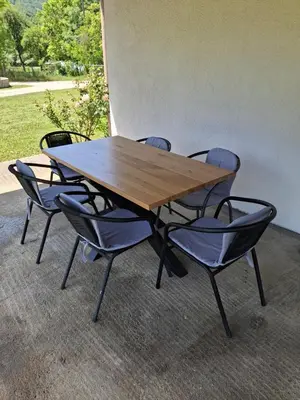 a wooden table with four chairs around it at Vikendica 