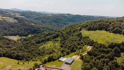 an aerial view of a house on a hill with trees at Villa Dos Padrinos in Banja Luka