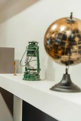 a table with a globe and a lamp on it at Villa Dos Padrinos in Banja Luka