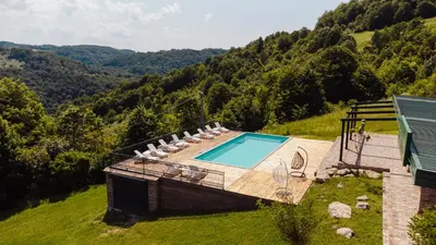 an overhead view of a swimming pool with lounge chairs at Villa Dos Padrinos in Banja Luka