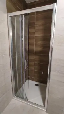 a shower stall with glass doors in a bathroom at Apartment Lena 51 in Banja Luka