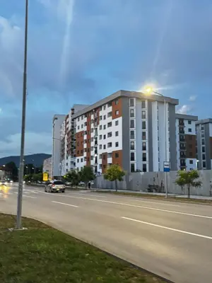 a building on the side of a city street at Belvedere Apartment in Doboj