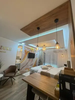 a hotel room with a large bed and a table at Belvedere Apartment in Doboj