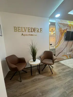 two chairs and a table in a room at Belvedere Apartment in Doboj