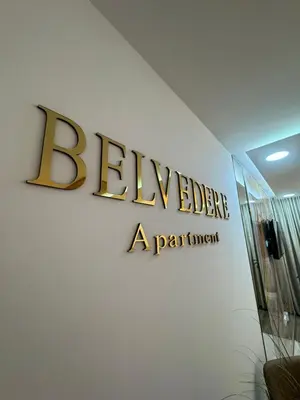 a sign for the bleecker apartment building on a wall at Belvedere Apartment in Doboj