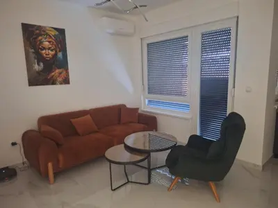 a living room with a couch and a table at SD apartman - Trn in Ivišovo Greblje