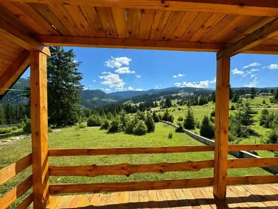 a view from the deck of a cabin in the mountains at Woodenhouse Ede Vlasic in Kutlovac