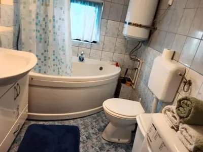 a bathroom with a toilet and a tub and a sink at Apartman Bojan in Prnjavor