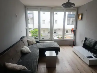 a living room with a couch and a tv at Apartman Mejdan in Banja Luka