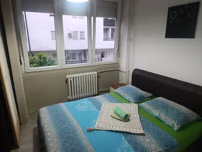 a bedroom with a bed with a tray on it at Apartman Mejdan in Banja Luka