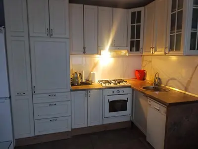 a kitchen with white cabinets and a stove top oven at Apartman Mejdan in Banja Luka