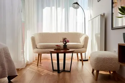 a living room with a chair and a table at Lovely and cozy apartment Lena in Zenica