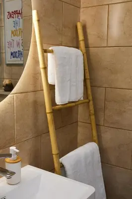a bathroom with a towel rack next to a sink at Lovely and cozy apartment Lena in Zenica