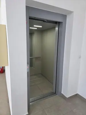 a sliding glass door in a room with a mirror at Apartman Garden 44 in Doboj