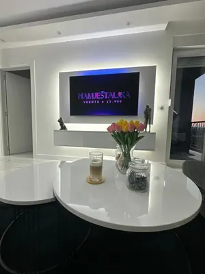 a living room with a white table with flowers on it at Apartment Aristos in Modriča