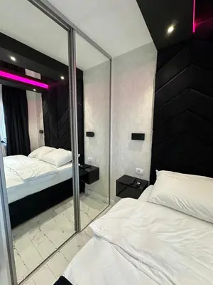 a bedroom with two beds and a mirror at Apartment Aristos in Modriča
