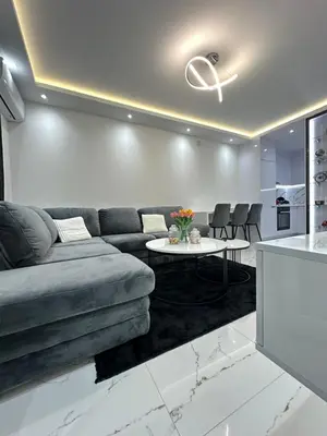 a living room with a couch and a table at Apartment Aristos in Modriča