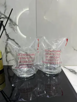 two empty glasses sitting on top of a counter at Apartment Aristos in Modriča