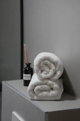 a stack of towels sitting on top of a shelf at Apartments NIM in Jajce
