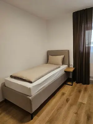 a bedroom with a bed and a window at Apartments NIM in Jajce