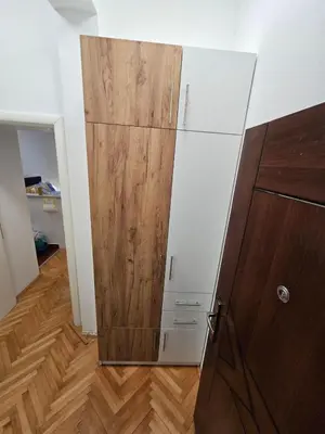 a closet with a wooden door in a room at GiV Apartman in Prijedor