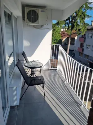 a balcony with a table and a chair at Nika-Simka in Banja Luka