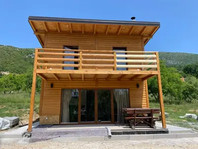 a tiny house with a deck on top of it at Vikendica Diva