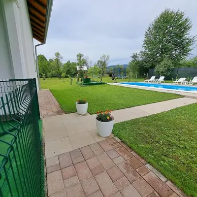 two potted plants on a patio next to a pool at Oaza mira BK in Bosanska Krupa
