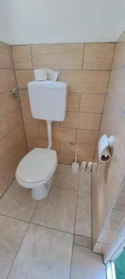 a bathroom with a white toilet in a room at Oaza mira BK in Bosanska Krupa
