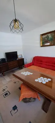 a living room with a red couch and a table at Oaza mira BK in Bosanska Krupa
