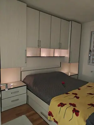 a bedroom with a bed with red flowers on it at Urban escape in Doboj