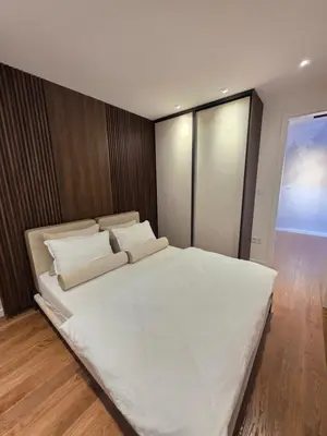 a large white bed in a room with a window at Moments IV Banja Luka in Banja Luka
