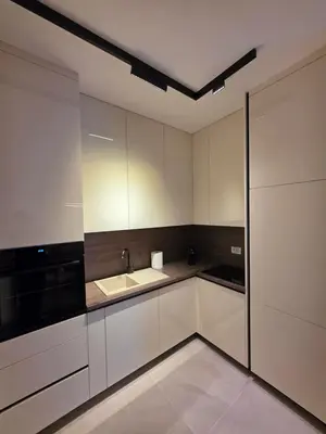 a kitchen with white cabinets and a sink at Moments IV Banja Luka in Banja Luka