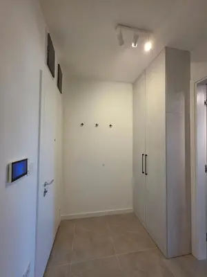 a room with white walls and a closet and a door at Moments IV Banja Luka in Banja Luka
