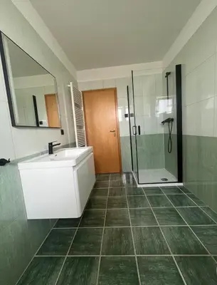 a bathroom with a sink and a shower at Apartman Delminium in Tomislavgrad