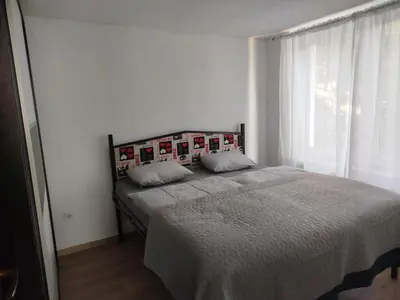a bed in a bedroom with a large window at Apartman KULA Livno in Livno
