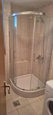 a shower with a glass door in a bathroom at Apartman KULA Livno in Livno