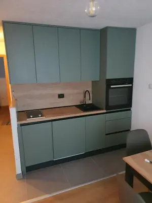 a kitchen with blue cabinets and a sink at Apartman KULA Livno in Livno