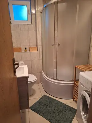 a bathroom with a shower and a toilet and a sink at Apartman KULA Livno in Livno