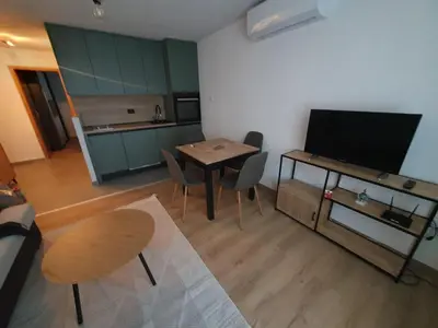 a living room with a table and a television at Apartman KULA Livno in Livno