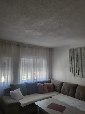 a living room with a couch and a window at Apartman MM in Bihać