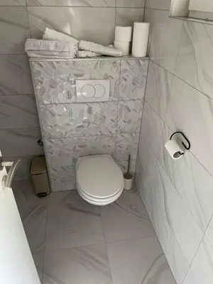 a bathroom with a white toilet and towels at Apartman BOBA in Jajce