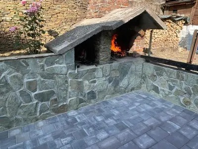 a stone oven with a fire inside of it at Apartman BOBA in Jajce