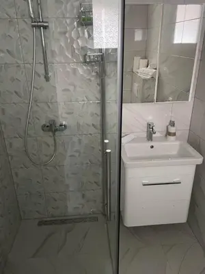 a bathroom with a shower and a sink at Apartman BOBA in Jajce