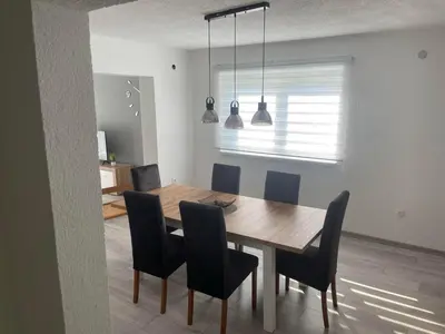 a dining room with a wooden table and chairs at Apartman BOBA in Jajce