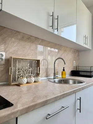 a kitchen with a sink and a counter top at Apartman Gold Jajce in Jajce