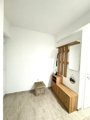 a room with a bench and a mirror at Apartman Gold Jajce in Jajce