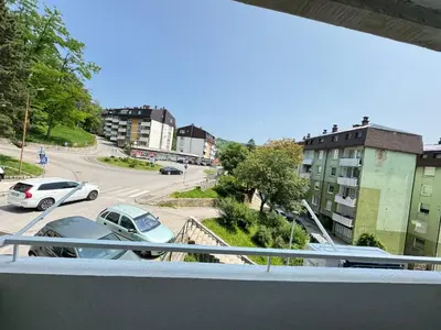 a balcony with a view of a parking lot with cars at Apartman Gold Jajce in Jajce