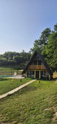 a house on a hill with a grassy field at Vikendica Buzadzija M&N